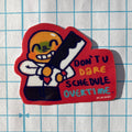 Sticker with a character holding a knife and text on a grid background