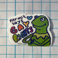 Sticker with a green character and text on a grid background