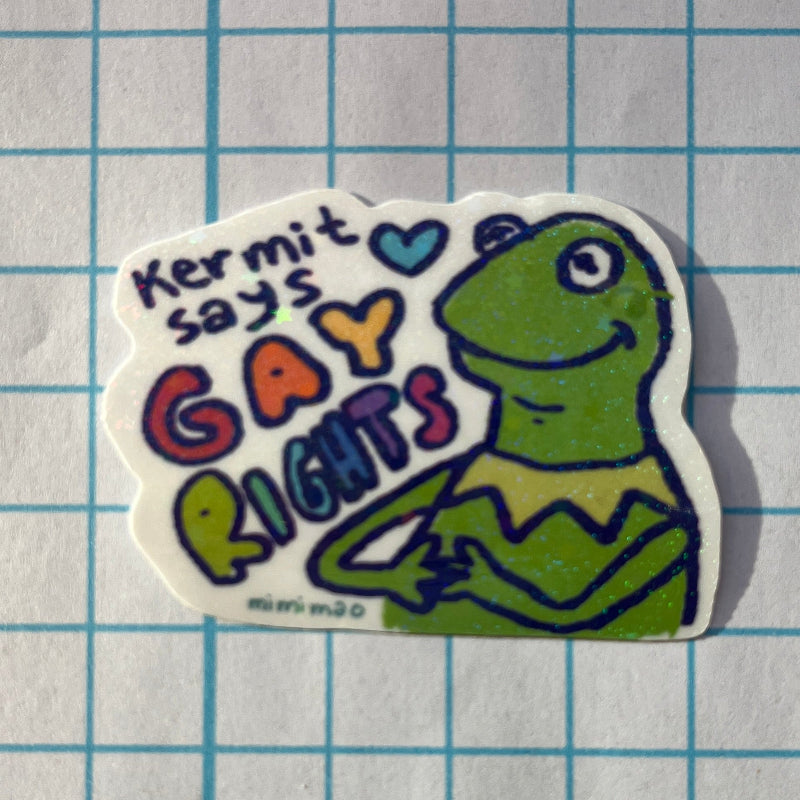 Sticker with a green character and text on a grid background