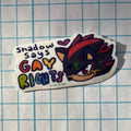 Sticker with a character and 'Shadow Says Gay Rights' text on a grid background