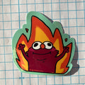 Cartoon character with flame-like design on a grid background