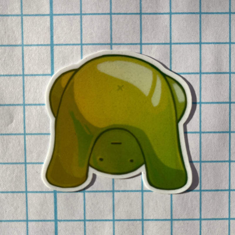 Green cartoon elephant sticker on a grid background