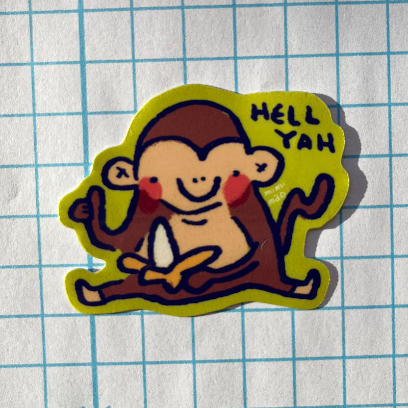 Sticker of a monkey with 'HELL YAH' text on a grid background