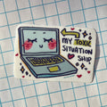 Sticker with a laptop illustration and text 'My Toxic Situation' on a grid background