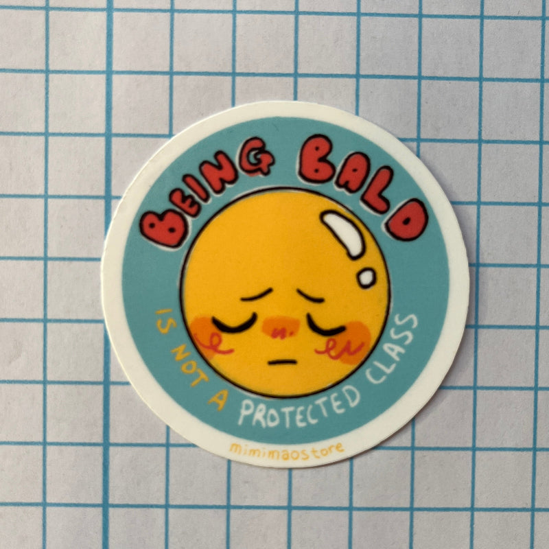 Sticker with a cartoon face and text on a grid background