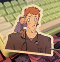Sticker of a person with an old man on shoulders held by tweezers over a colorful keyboard and desk.